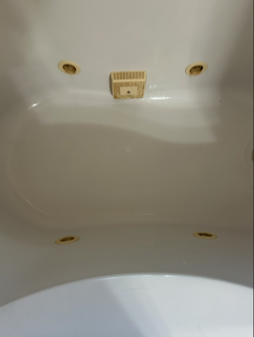 The same jetted tub restored to a clean, glossy finish