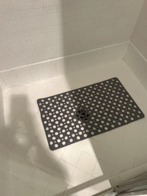 The same tile shower floor bright and clean after cleaning